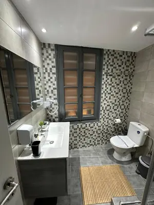 a bathroom with a sink and a toilet in it at ROH Suites in Athens