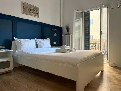 a bedroom with a large bed with a blue headboard at B&B Boutique Two Bedrooms Apartments in Athens