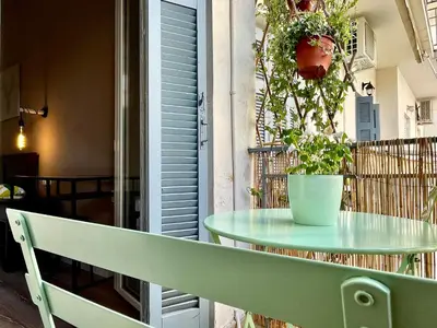 a green table with a potted plant on a balcony at B&B Boutique Two Bedrooms Apartments in Athens