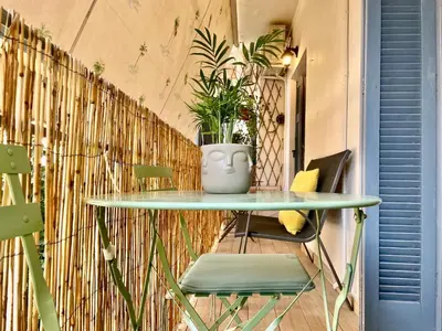 a table and chairs in front of a wall with a vase at B&B Boutique Two Bedrooms Apartments in Athens