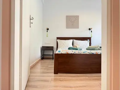 a bedroom with a bed and a table with a cross at B&B Boutique Two Bedrooms Apartments in Athens