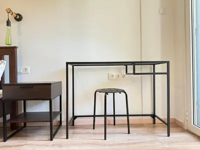 a black bar stool next to a table and a desk at B&B Boutique Two Bedrooms Apartments in Athens