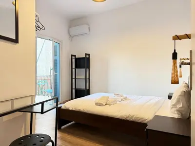 a bedroom with a bed and a desk and a window at B&B Boutique Two Bedrooms Apartments in Athens
