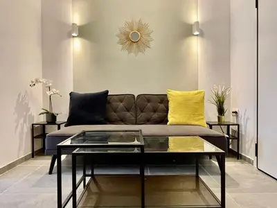a living room with a couch and a glass table at B&B Boutique Two Bedrooms Apartments in Athens