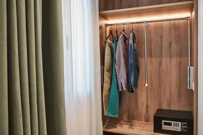 a room with a closet with a curtain and clothes at NLH KERAMEIKOS - Neighborhood Lifestyle Hotels in Athens