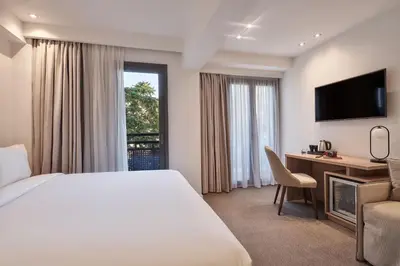 a hotel room with a bed and a television at NLH KERAMEIKOS - Neighborhood Lifestyle Hotels in Athens