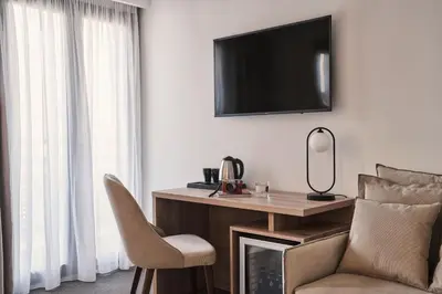 a room with a desk and a chair and a television at NLH KERAMEIKOS - Neighborhood Lifestyle Hotels in Athens