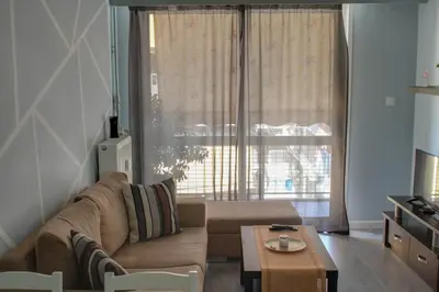 a living room with a couch and a table at Modern Cozy Apartment in Downtown Athens in Athens