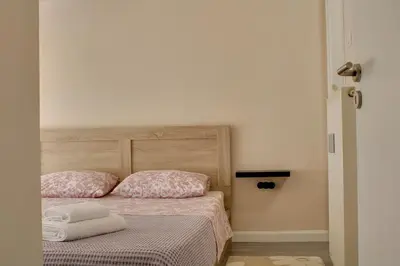 a bedroom with a bed with two towels on it at Modern Cozy Apartment in Downtown Athens in Athens