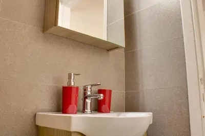 a bathroom with a sink and a mirror at Modern Cozy Apartment in Downtown Athens in Athens