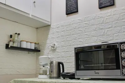 a microwave sitting on a counter in a kitchen at Modern Cozy Apartment in Downtown Athens in Athens