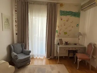 a living room with a chair and a desk and a window at The Magnolia - Sophisticated residence in Athens