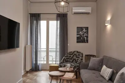 a living room with a couch and a table at Ilisia Park Contemporary 2BD Condo in Athens