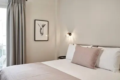 a bedroom with a white bed and a window at Ilisia Park Contemporary 2BD Condo in Athens