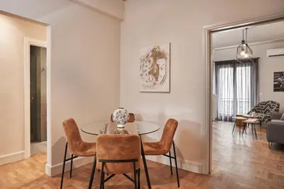 a dining room and living room with a table and chairs at Ilisia Park Contemporary 2BD Condo in Athens