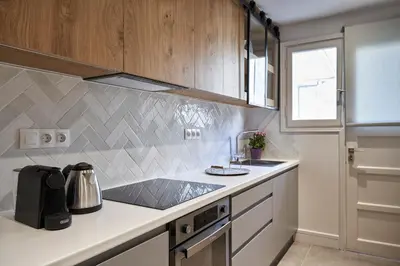 a kitchen with a sink and a refrigerator at Ilisia Park Contemporary 2BD Condo in Athens