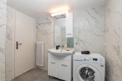 a bathroom with a washing machine and a sink at Marina Zeas Livemodern in Piraeus