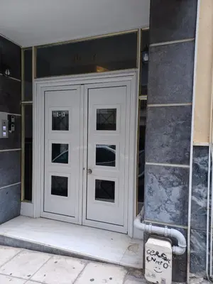 a white door on the side of a building at Marina Zeas Livemodern in Piraeus