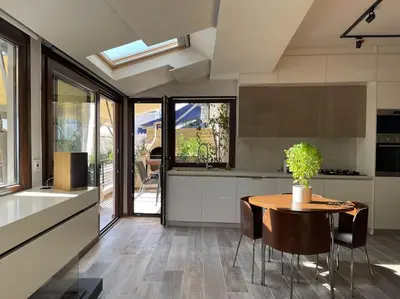 a kitchen with a table and chairs in a kitchen at Acropolis Lux Apartment in Athens
