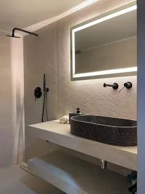 a bathroom with a sink and a mirror at Acropolis Lux Apartment in Athens