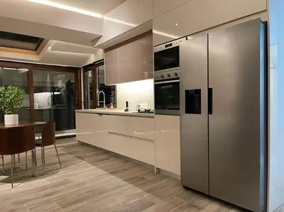 a kitchen with stainless steel appliances and a table at Acropolis Lux Apartment in Athens