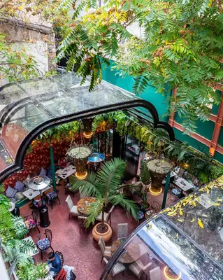 an overhead view of a patio with tables and plants at Mamy Blue Slow Living in Athens