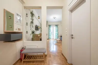 a living room with a bench and a mirror at Boutique Suite by CloudKeys in Athens