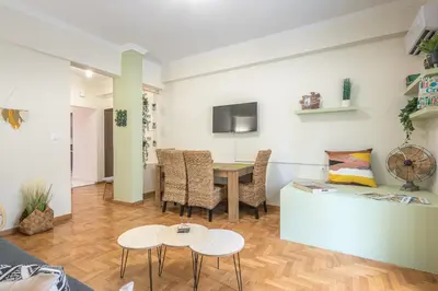 a living room with a table and a couch at Boutique Suite by CloudKeys in Athens