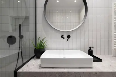 a bathroom with a white tub and a mirror at Here Comes The Sun in Athens
