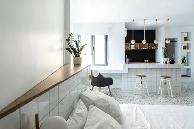 a living room with a couch and a kitchen at Here Comes The Sun in Athens