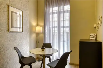 a room with a table and chairs and a window at Plaka Filotheis House B in Athens