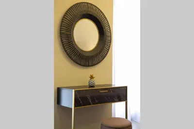 a mirror on a wall with a table and a chair at Plaka Filotheis House B in Athens