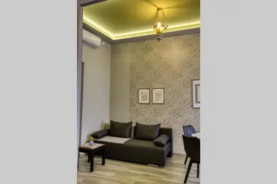 a living room with a couch and a table at Plaka Filotheis House B in Athens