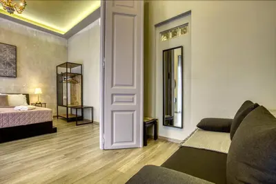 a living room with a couch and a bed and a mirror at Plaka Filotheis House B in Athens