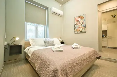 a bedroom with a bed with towels on it at Plaka Filotheis House A in Athens