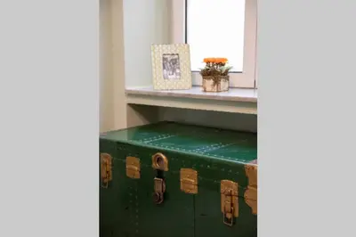 a green suitcase sitting on the floor next to a window at Plaka Filotheis House A in Athens