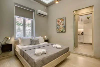 a bedroom with a large bed with towels on it at Plaka Filotheis House A in Athens