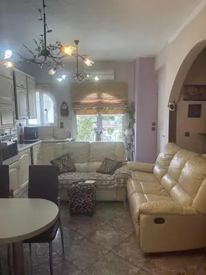 a living room with a couch and a table at Mandy's cosy luxury flat in Piraeus