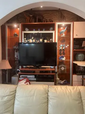 a living room with a couch and a flat screen tv at Mandy's cosy luxury flat in Piraeus