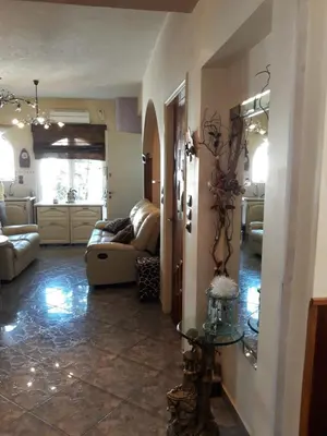 a living room with a couch and a table at Mandy's cosy luxury flat in Piraeus