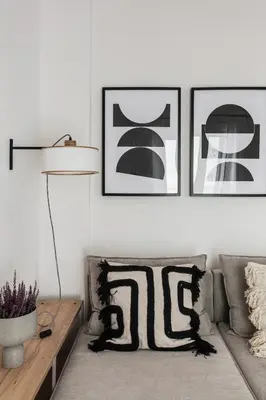a living room with a couch and three pictures on the wall at Pristine 1BR Apartment in Ampelokipoi Area by UPSTREET in Athens