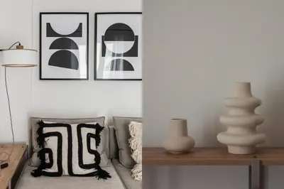 a living room with black and white pictures and a table at Pristine 1BR Apartment in Ampelokipoi Area by UPSTREET in Athens