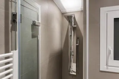 a shower in a bathroom with a glass door at Pristine 1BR Apartment in Ampelokipoi Area by UPSTREET in Athens