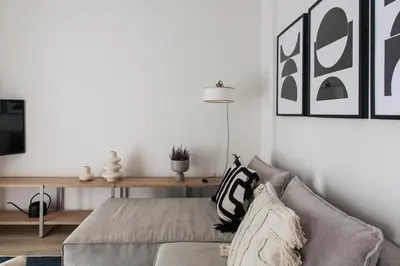a living room with a couch and a table at Pristine 1BR Apartment in Ampelokipoi Area by UPSTREET in Athens