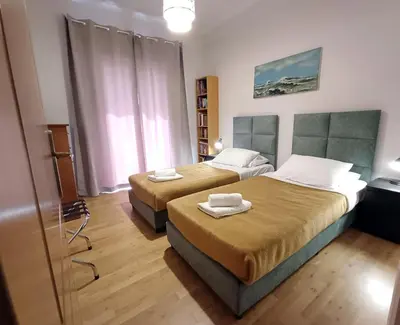 a bedroom with two beds with towels on them at Georgia's Cozy Apartment in Koukaki in Athens