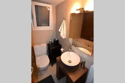 a bathroom with a sink and a toilet and a tub at Georgia's Cozy Apartment in Koukaki in Athens