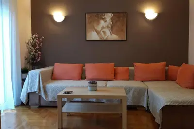 a living room with a couch and a table at Georgia's Cozy Apartment in Koukaki in Athens