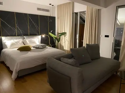 a bedroom with a bed and a couch at Athinaion Recreation Suites in Athens