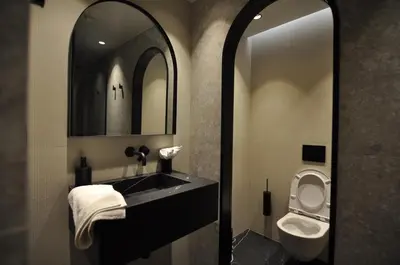 a bathroom with a sink and a toilet and a mirror at Athinaion Recreation Suites in Athens