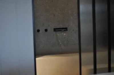 a bath tub with water coming out of a glass door at Athinaion Recreation Suites in Athens